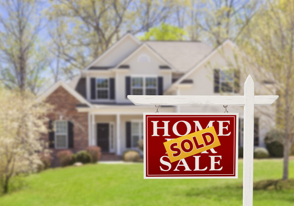 Sold Home For Sale Real Estate Sign and Beautiful New House.