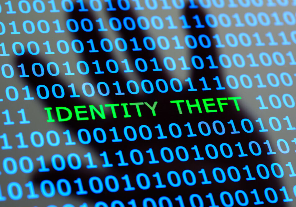 Internet identity theft on a digital tablet with reflection of hackers hand concept for online digital crime