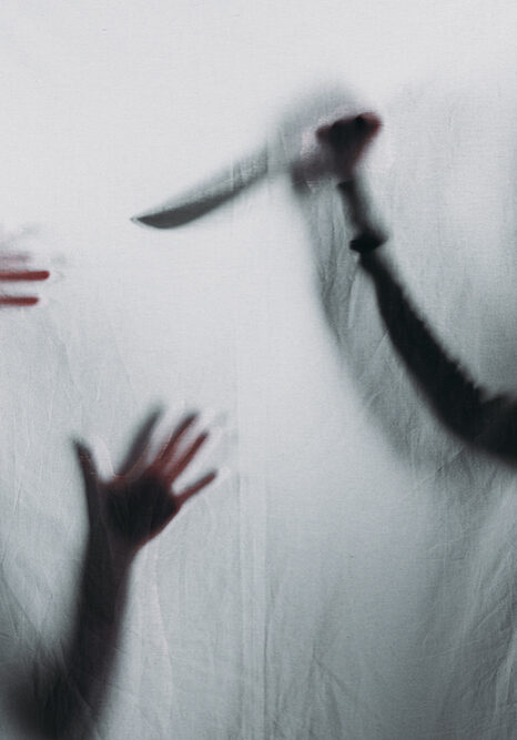silhouette of someone holding knife and murdering victim, crime concept